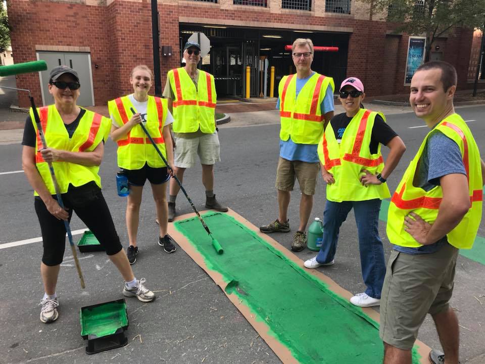 Volunteers paint bike crossings in Uptown